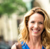 Urban Mature Blond Woman looking at the camera smiling showing confidence